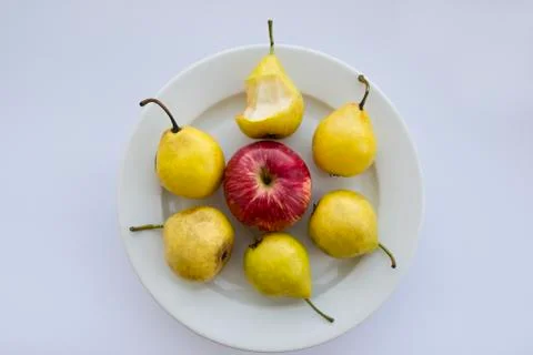 Bitten pear on white plate Foto stock