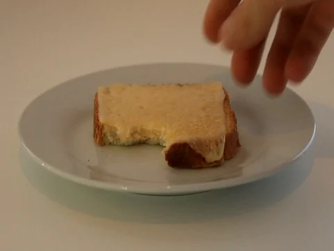 Bitten piece of bread Stock Footage
