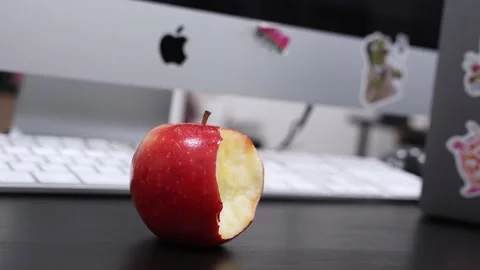 Bitten Red Apple on Apple iMac Office Desk Stock Footage 336328217