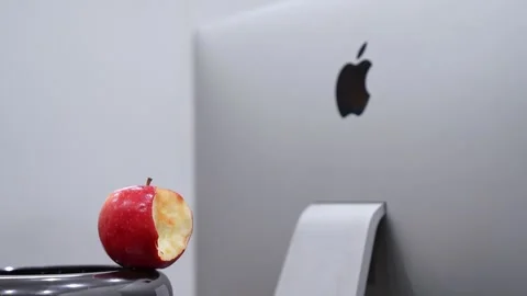 Bitten Red Apple Next To Apple iMac Stock Footage 336604411
