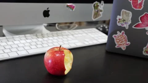 Bitten Red Apple on Silver Apple iMac Workstation Stock Footage 336327858