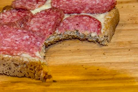A bitten slice of salami Foto stock