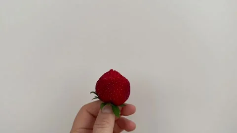 Bitten strawberry in hand Stock Footage 244595781