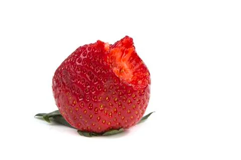 Bitten of strawberry on white Stock Photos