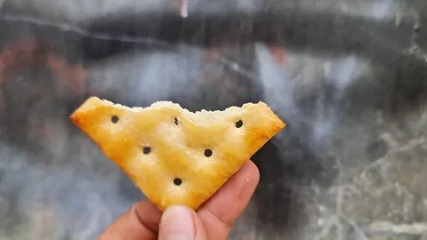 Bitten Sweet Cracker in Hand Concept of Enjoying Crunchy Delicious Snack Break Stock Footage 333754195