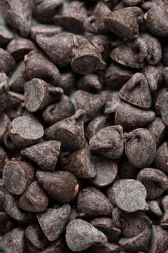 Bitter chocolate drops pattern. Closeup top view confectionery dark chocolate Stock Photos