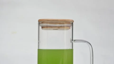Bitter gourd or bitter melon juice on white background. Видео 330114163