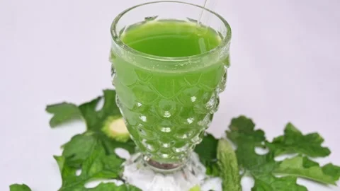 Bitter gourd or bitter melon juice on white background. 库存影片 330114165