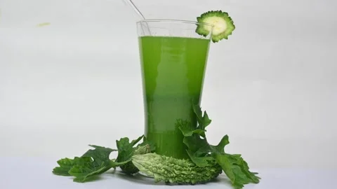 Bitter gourd or bitter melon juice on white background. 库存影片 330114190