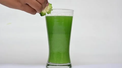Bitter gourd or bitter melon juice on white background. 库存影片 330114320