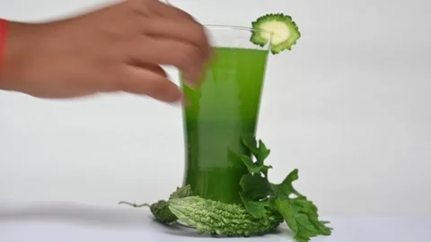 Bitter gourd or bitter melon juice on white background. 库存影片 330114321