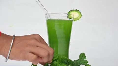 Bitter gourd or bitter melon juice on white background. Видео 330114404