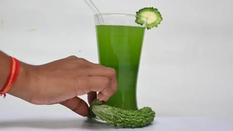 Bitter gourd or bitter melon juice on white background. Vidéo 330114658