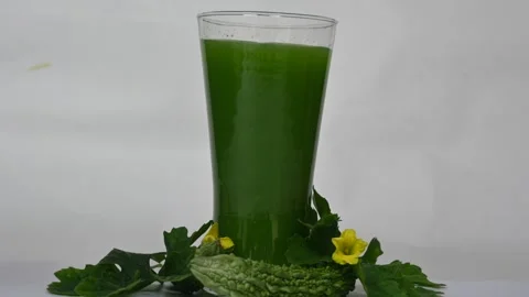 Bitter gourd or bitter melon juice on white background. 库存影片 330115352