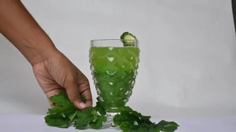 Bitter gourd or bitter melon juice on white background. 库存影片 330115381