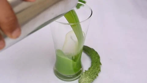 Bitter gourd or bitter melon juice on white background. 库存影片 330209425