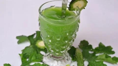 Bitter gourd or bitter melon juice on white background. Stock Footage 330209436