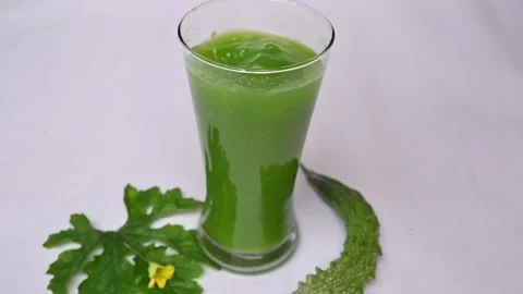 Bitter gourd or bitter melon juice on white background. Stock Footage 330209475