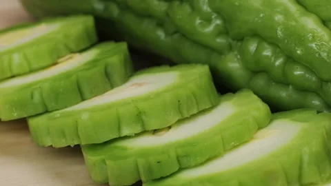 A bitter gourd, a vegetable often used as an ingredient in cuisine, is placed on Stock Footage 274745603