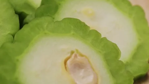 A bitter gourd, a vegetable often used as an ingredient in cuisine, is placed on Stock Footage 274745767