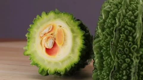 A bitter gourd, a vegetable often used as an ingredient in cuisine, is placed on Stock Footage 275095601