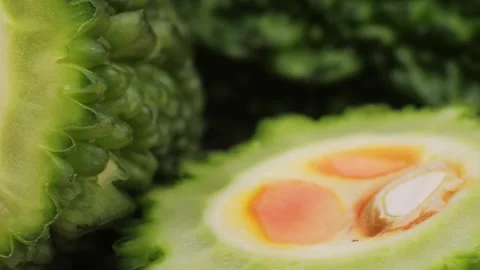 A bitter gourd, a vegetable often used as an ingredient in cuisine, is placed on Stock Footage 275844936