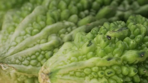 A bitter gourd, a vegetable often used as an ingredient in cuisine, is placed on Stock Footage 277418870