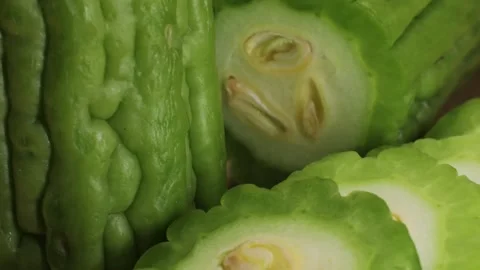 A bitter gourd, a vegetable often used as an ingredient in cuisine, is placed on Stock Footage 278537458
