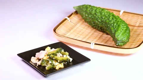 Bitter melon and bitter melon chanpuru (stir-fry), rotating Stock Footage 313815564