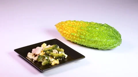 Bitter melon and bitter melon chanpuru (stir-fry), rotating Stock Footage 314201970