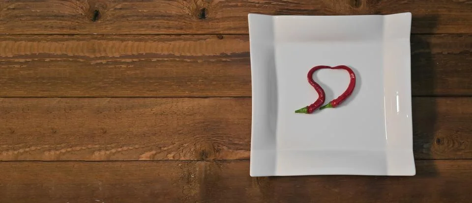 Bitter red pepper in the shape of a heart Stock Photos
