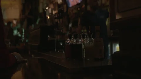 Bitters Bottles on Bar Counter in Dim Pub Stock Footage 343950505