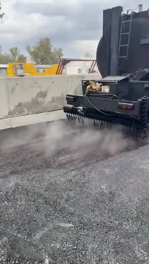 Bitumen Emulsion Spraying on Road Surface Stock Footage 323653994