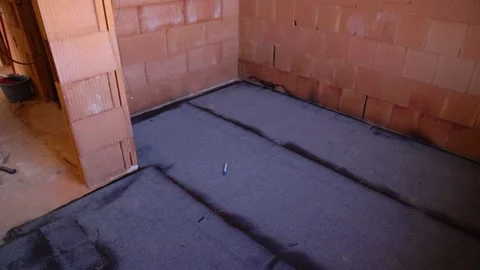 Bitumen membrane covers floor of unfinished house interior for waterproofing Stock Footage 311046478