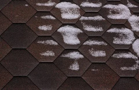 Bitumen roofing surface is covered with snow Stock Photos