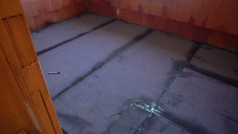 Bitumen waterproofing membrane applied on house floor with visible seams Stock Footage 311418582