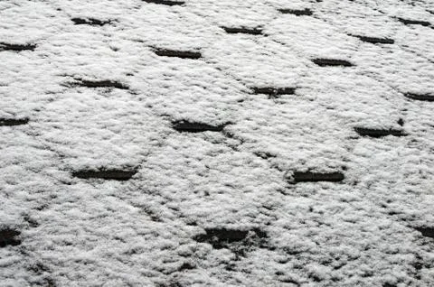 The bituminous roofing surface is covered with wet snow Stock Photos