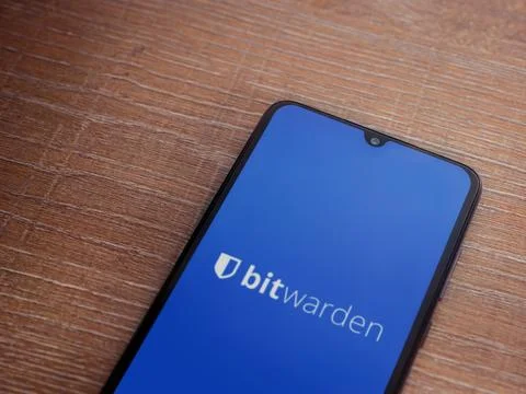 Bitwarden Password Manager app launch screen on smartphone on wooden backgrou Stock Photos