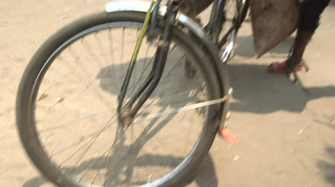 Bizarre bike loads 6:  securing a huge sack Stock Footage 49367026