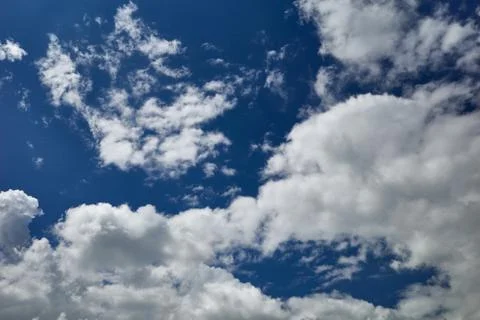 Bizarre cumulus clouds soar in the blue sky Stock Photos