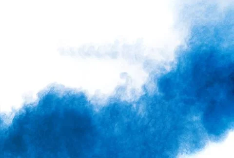 Bizarre forms of blue powder explosion cloud on white background. Stock Photos