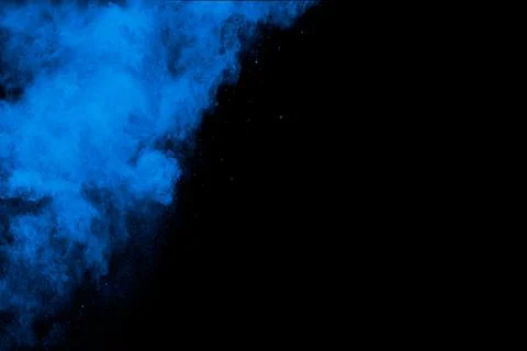 Bizarre forms of blue powder explosion cloud on white background. Foto stock