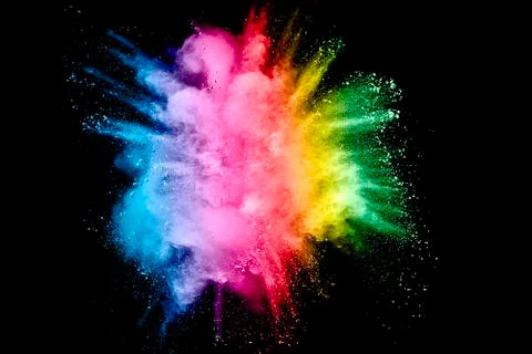 Bizarre forms of powder painted and flour combined explode in front of a blac Stock Photos