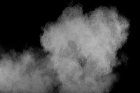 Bizarre forms of white powder explosion cloud against black background. Stock Photos