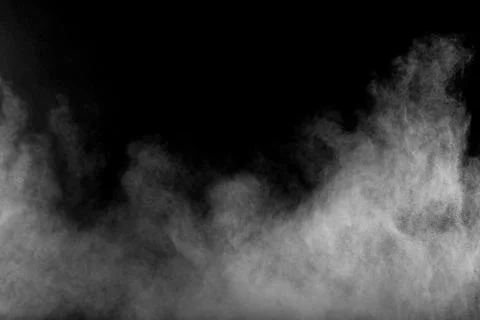 Bizarre forms of white powder explosion cloud against black background. Stock Photos