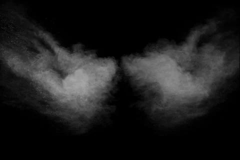 Bizarre forms of white powder explosion cloud against black background. Stock Photos