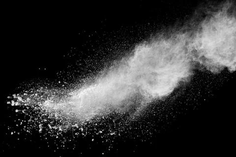Bizarre forms of white powder explosion cloud against black background. Stock Photos