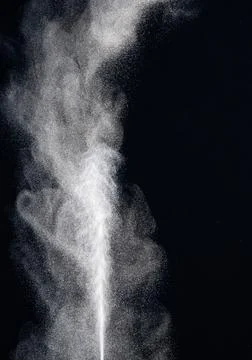 Bizarre forms of white powder explosion cloud against black background.White  Foto stock