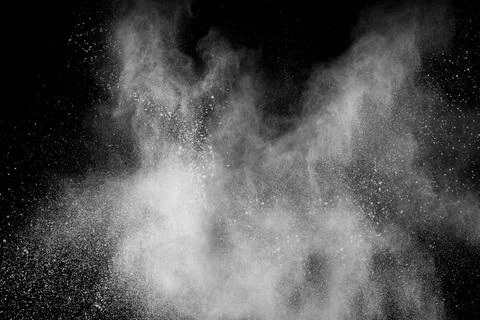 Bizarre forms of white powder explosion cloud against black background.Whi... Foto stock