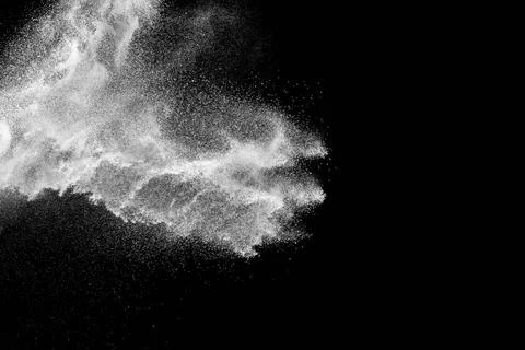 Bizarre forms of white powder explosion cloud against black background.Whi... Foto stock